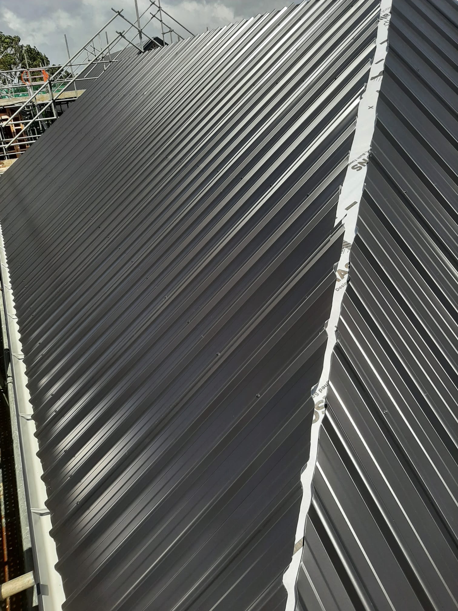 Close-up of charcoal Coloursteel ridge and flashing â€” Auckland
