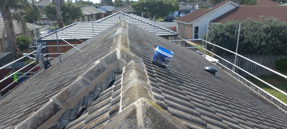 Ridge cap mortar re-bedding on clay roof